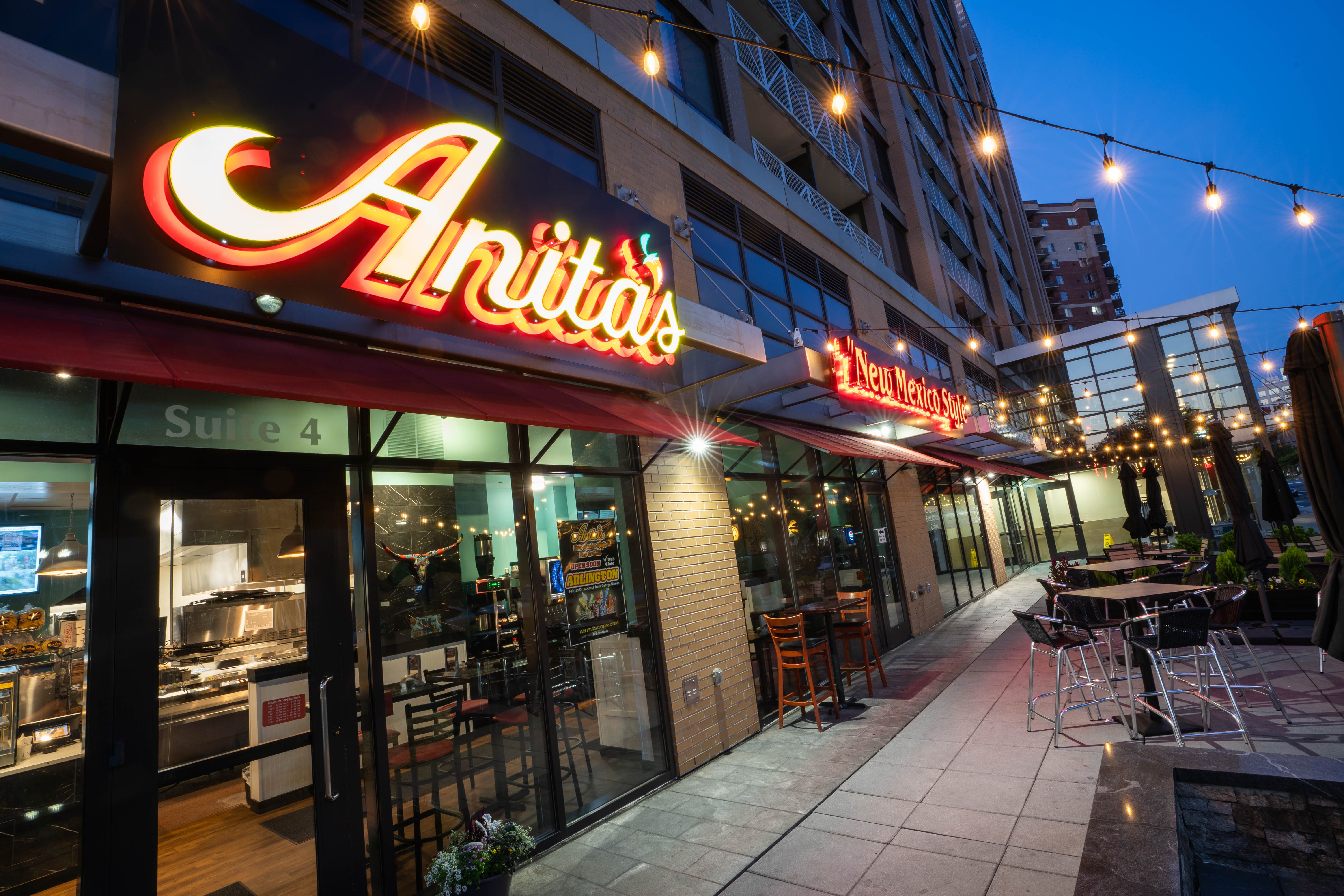 Actual Anita’s Arlington storefront at 3444 Fairfax Drive, with illuminated red chile apostrophe logo and patio at twilight